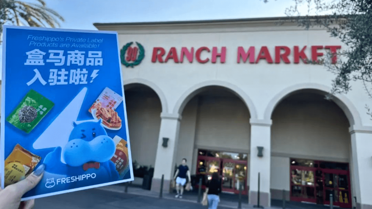 A promotional flyer advertising Freshippo’s private-label products in front of a 99 Ranch Market store.